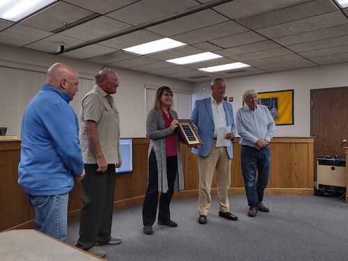 Commissioners present plaque in honor of Roger Umbaugh